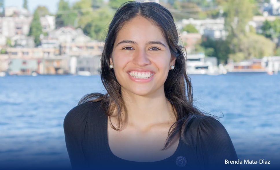 Opportunity Scholar smiling in front of a Lake