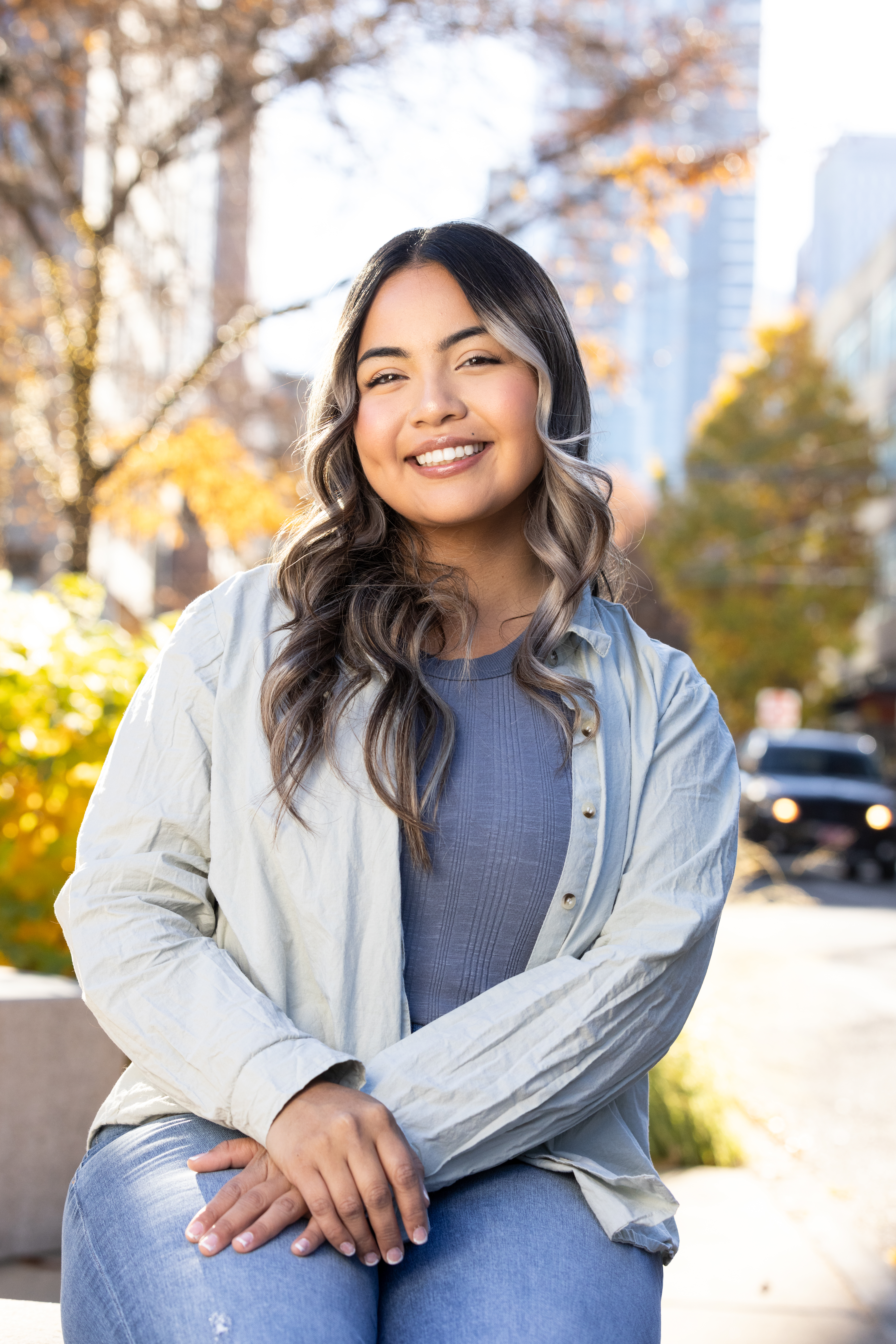 Woman smiling for a headshot outside in a city