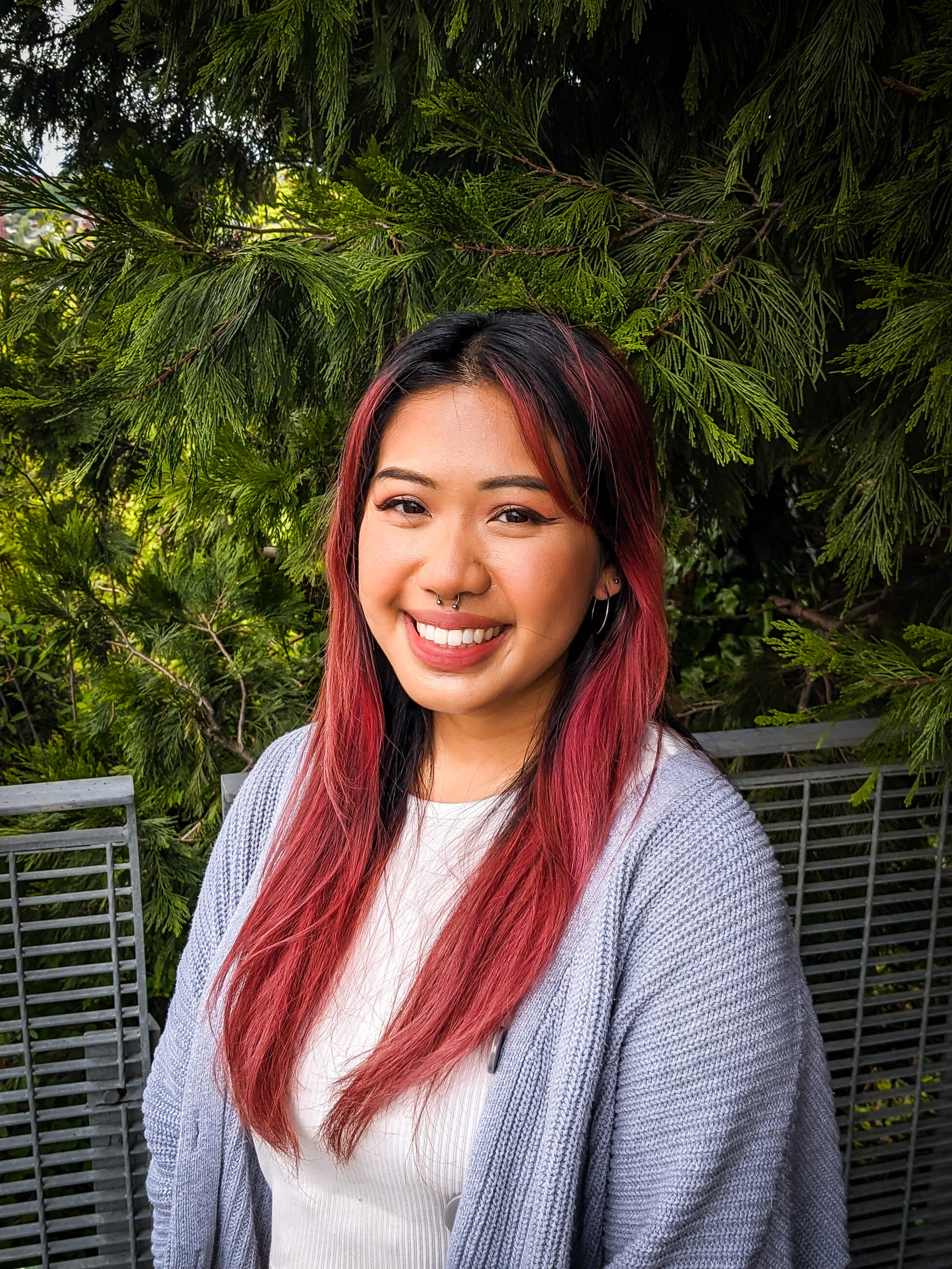 Headshot of woman smiling in front of trees