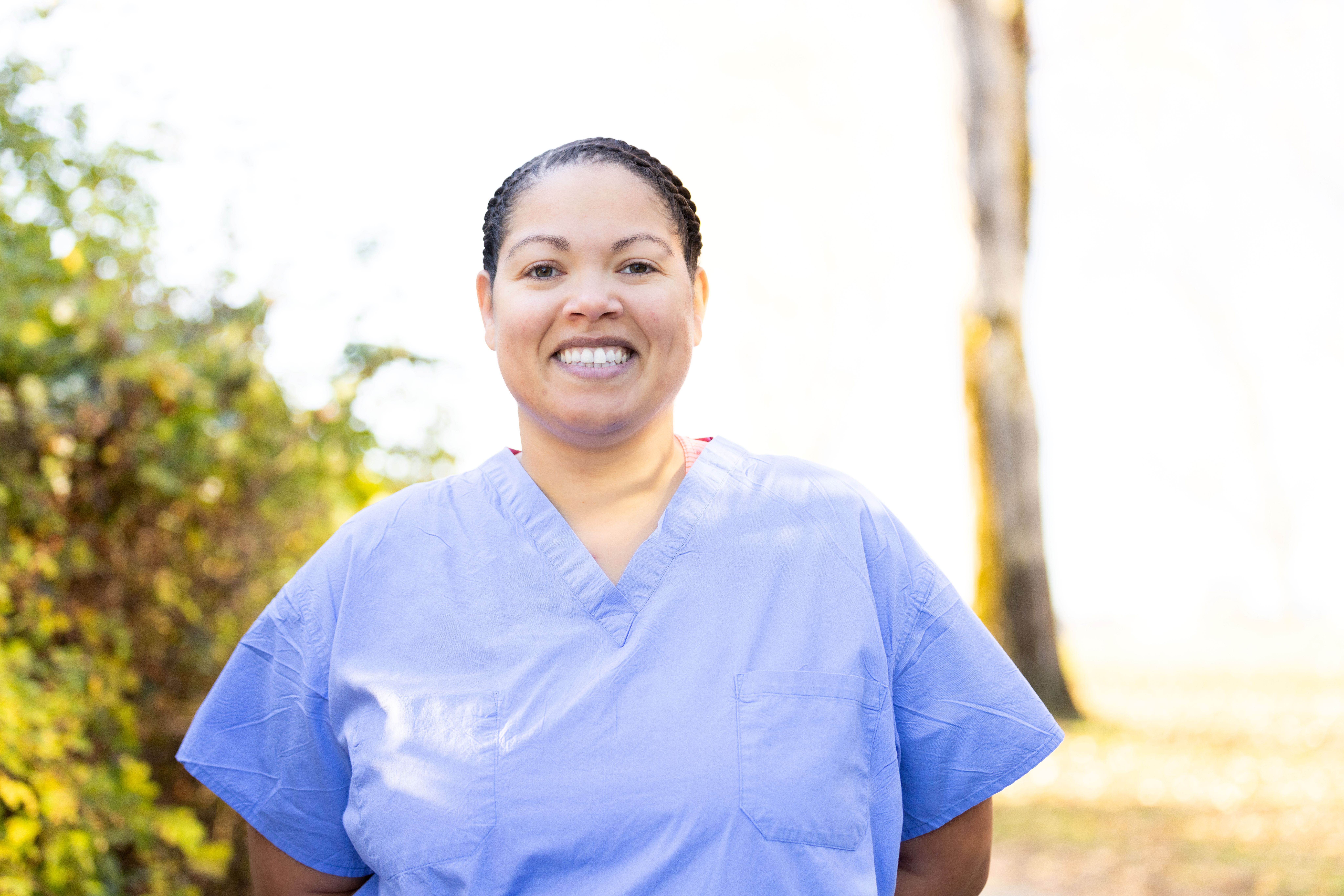 Graduate health care scholar smiling in scrubs