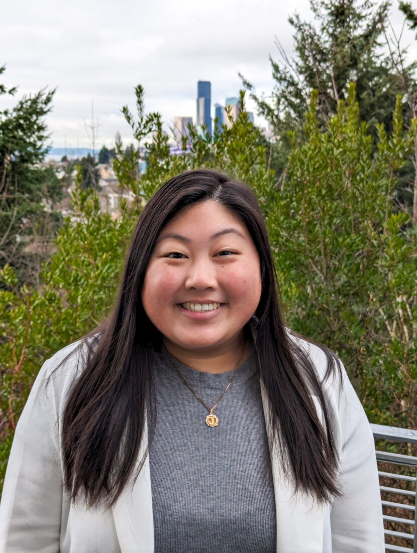 Headshot of woman smiling in front of trees