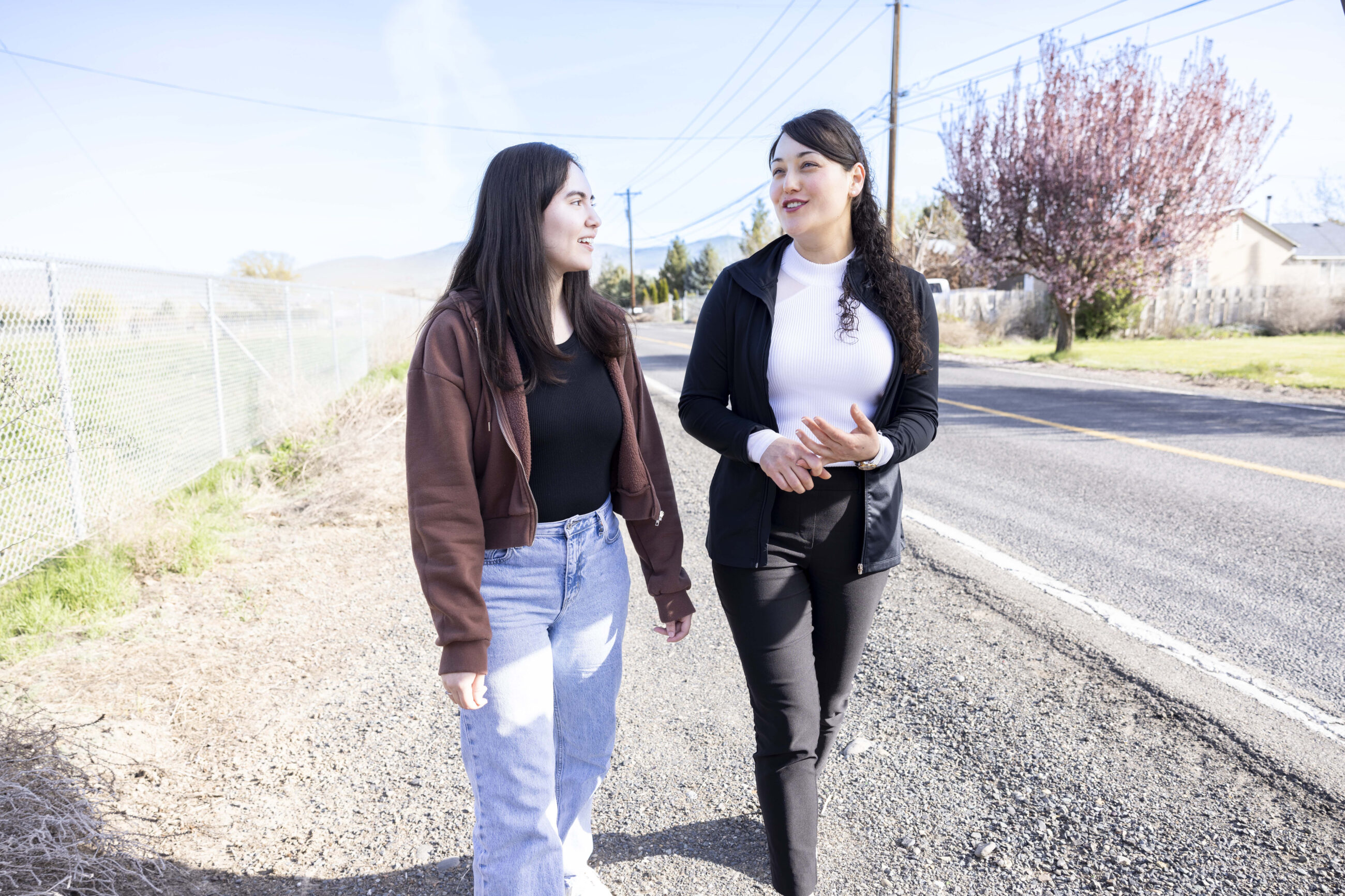 Two young adults walking in a rural setting