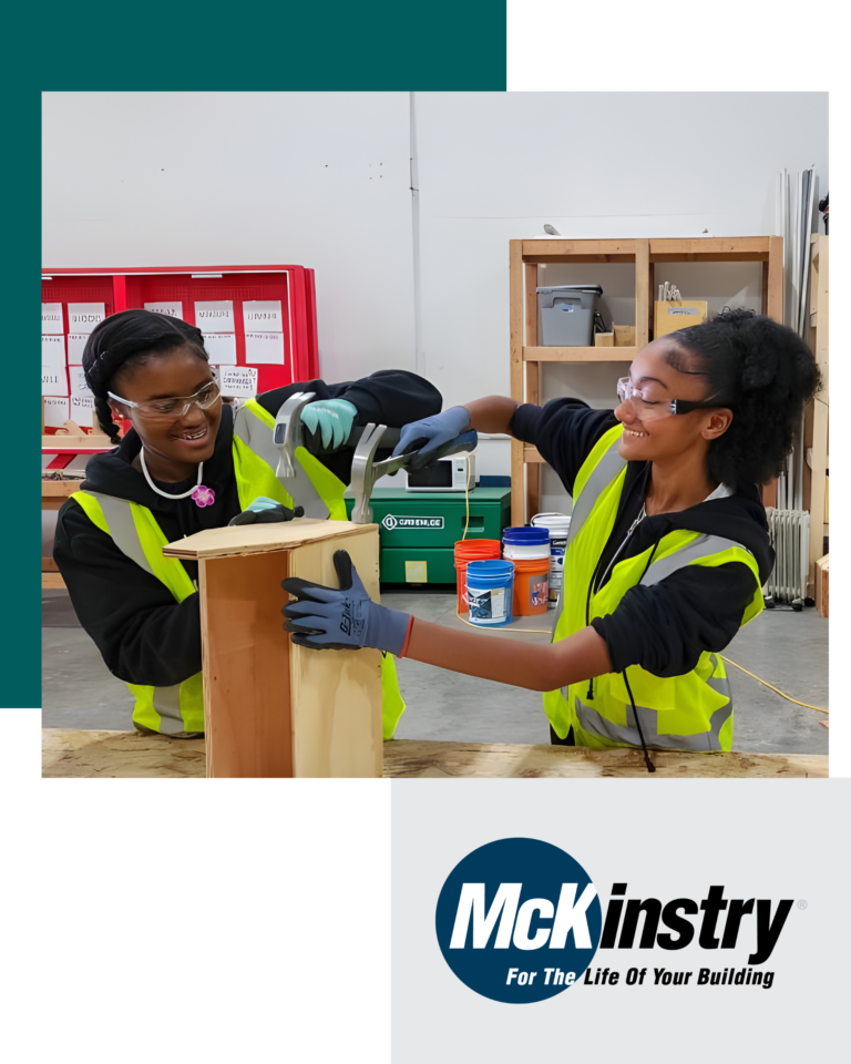 two female students working on a wood block